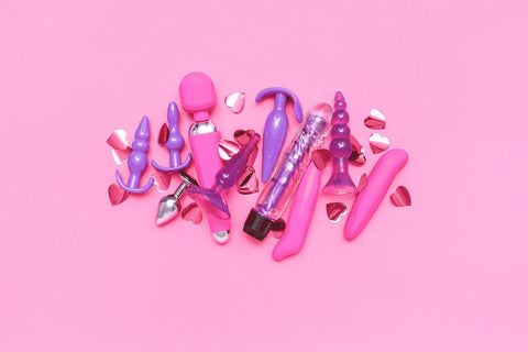 Sex Toy Company - Image of pink and purple sex toys on a pink background.